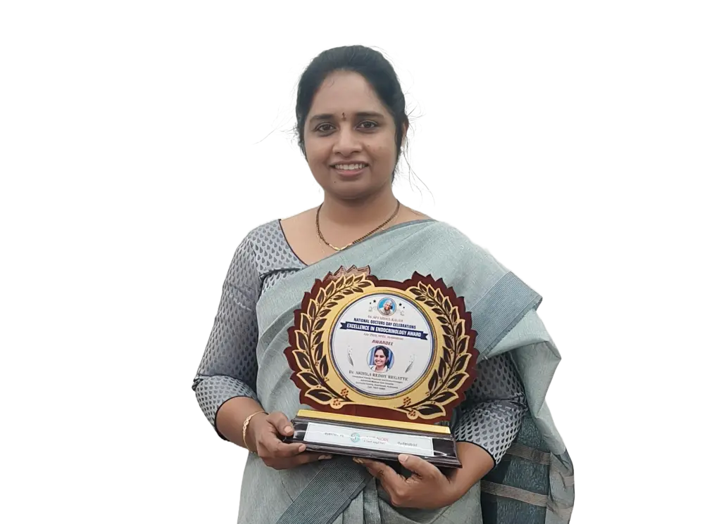 Dr. Akhila Reddy Regatte holding the "Excellence in Endocrinology Award" received during the National Doctors' Day Celebrations. The award features a circular gold leaf design and her portrait.